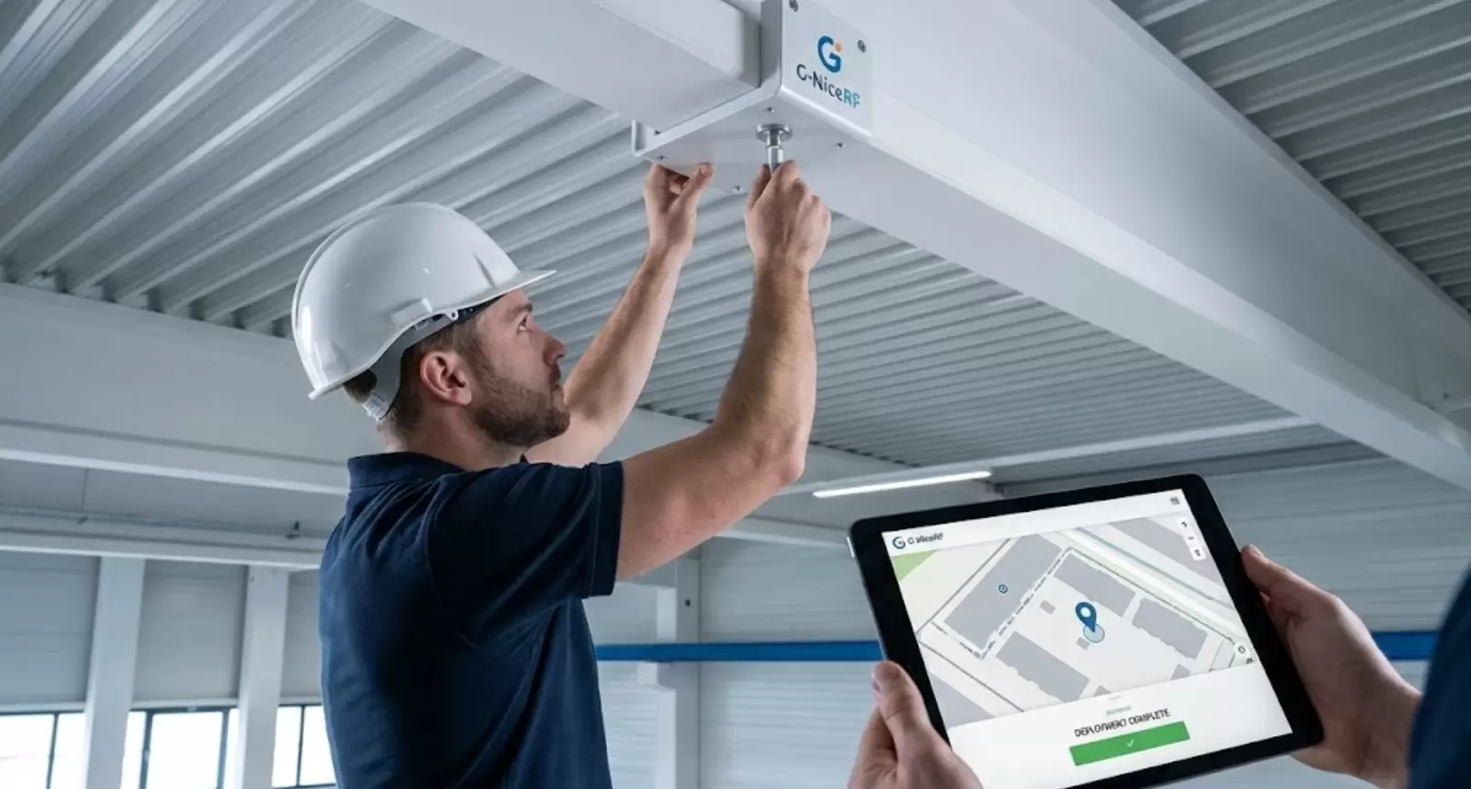 Technician installing a G-NiceRF UWB anchor with tablet support.